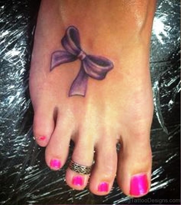 Adorable Purple Bow Tattoo On Foot