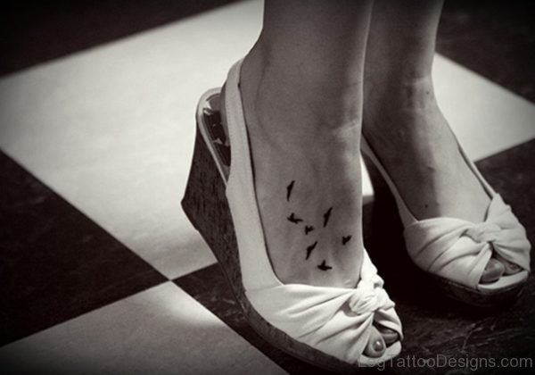 Black And White Bird Tattoo On Foot