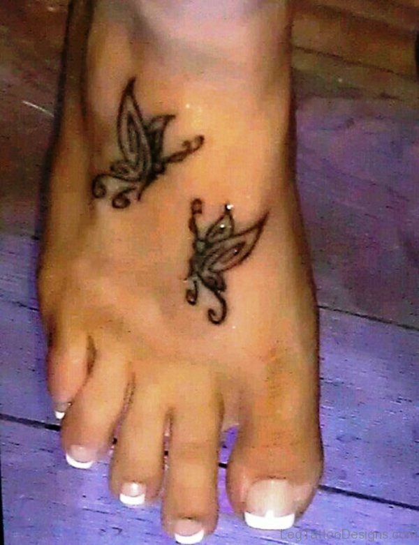 Black Tribal Butterflies Tattoo On Foot