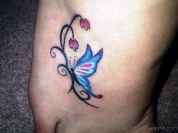 Blue Butterfly With Flowers Tattoo On Foot