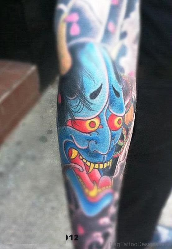 Blue Face Red Eyes Evil Tattoo On Leg