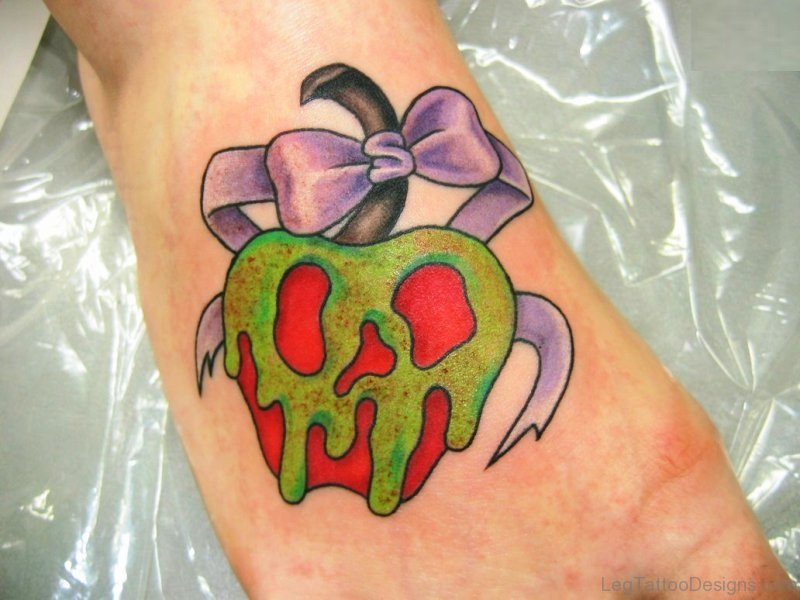 Bow And Apple Tattoo On Foot