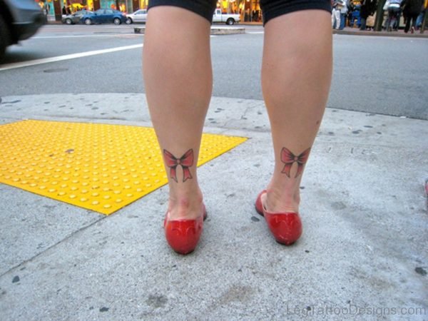 Cute Red Bow Tattoo On Leg