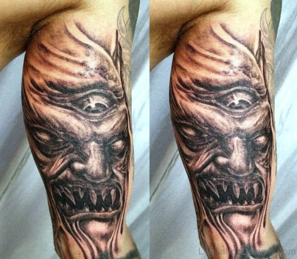 Evil Face Tattoo On Leg