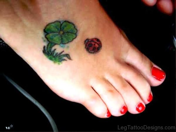 Ladybug With Shamrock Flowers Tattoo