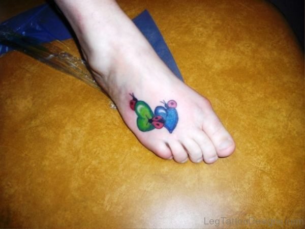 Ladybugs On Colorful Hearts Tattoo