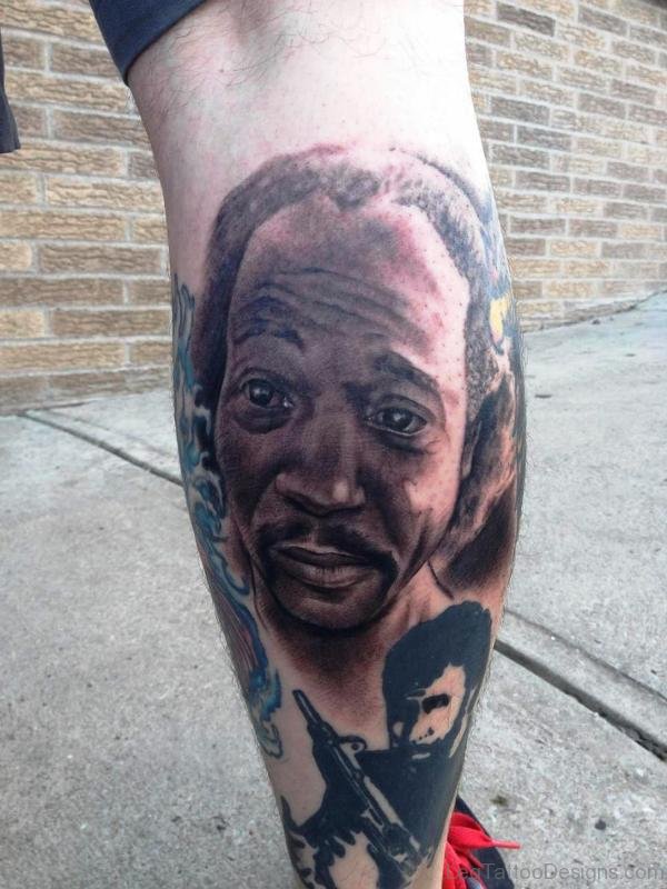 Man Face Tattoo On Calf