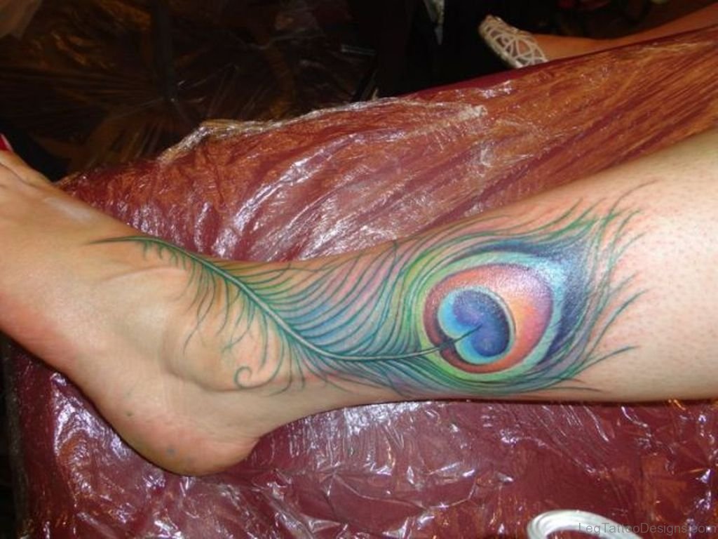 peacock feather tattoo on thigh