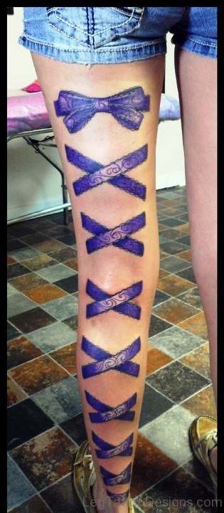 Purple Ink Corset Tattoo On Leg