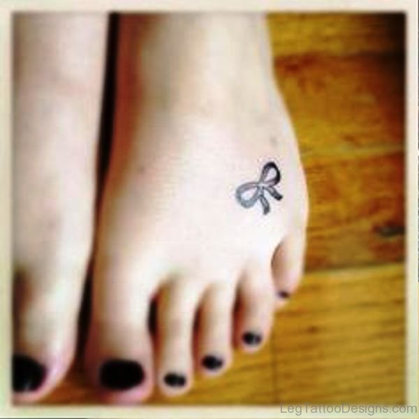Small Black Bow Tattoo On Foot