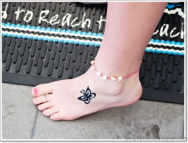 Tiny Black Butterfly Tattoo On Foot