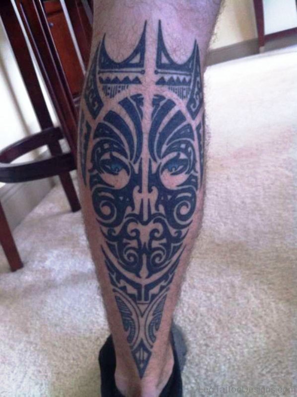 Tribal Face Tattoo On Calf