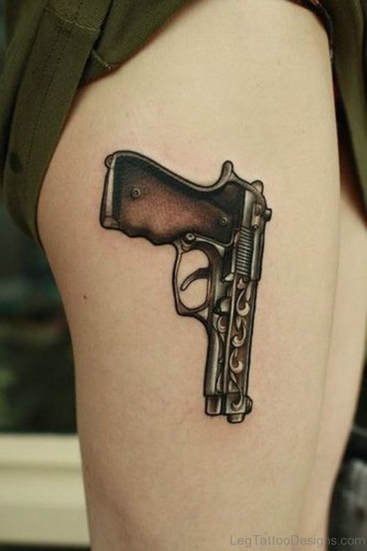 Attractive Gun Tattoo On Thigh