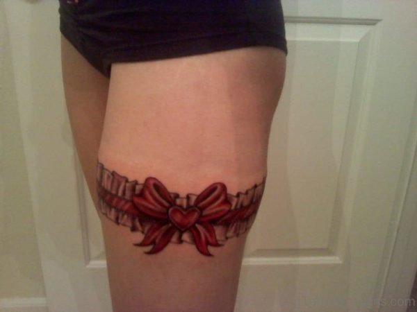 Attractive Red Bow Tattoo On Thigh