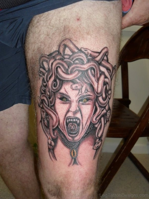 Black And Grey Horror Medusa Face Tattoo On Man Thigh