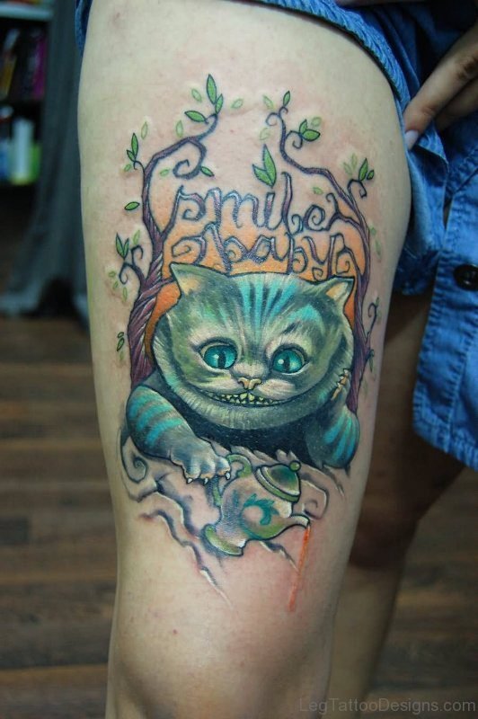 Blue Cheshire Cat Tattoo On Thigh