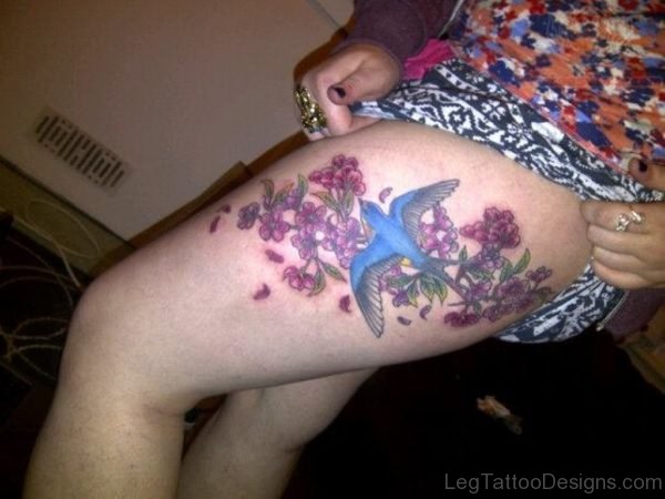 Blue Swallow And Flowers Tattoo On Thigh