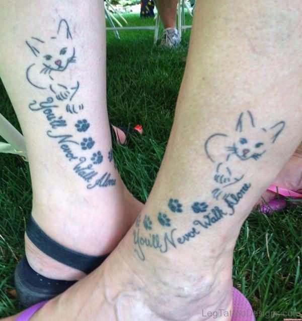 Cat And Lettering Tattoo On Leg