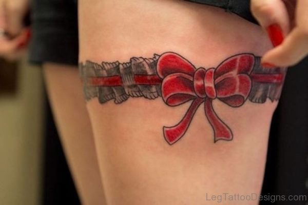 Cute Red Bow Tattoo On Thigh