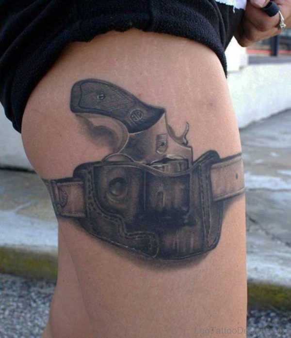 Excellent Gun Tattoo On Thigh