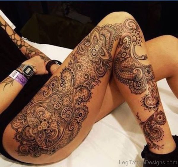 Flower And Tribal Tattoo On Thigh Image