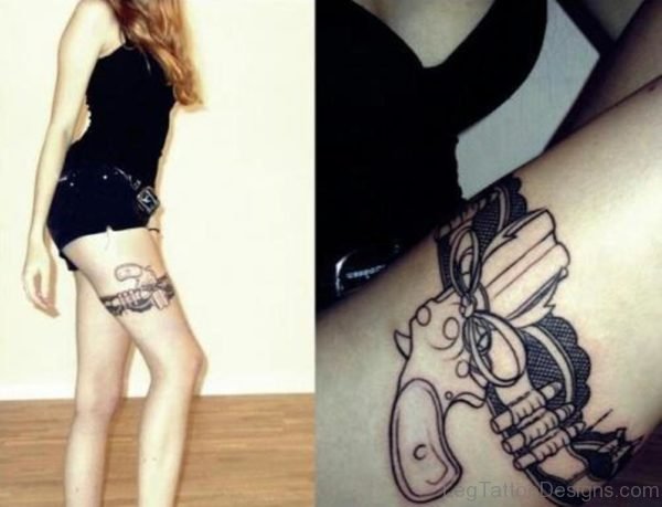 Girl With Gun Tattoo On Thigh