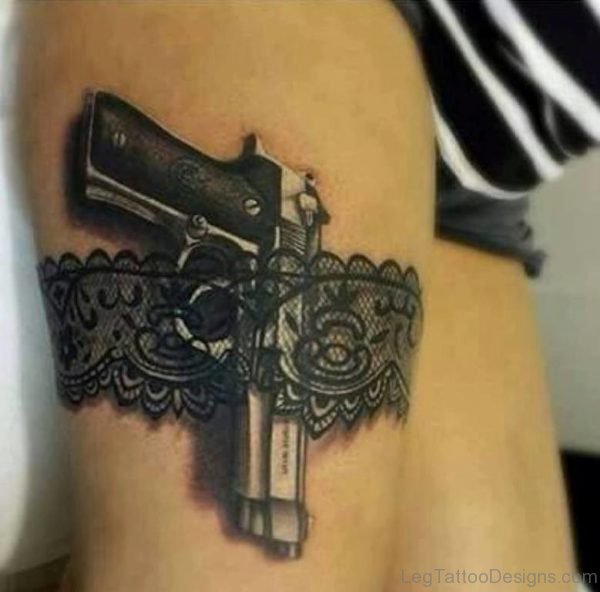 Gun And Lace Garter Tattoo On Thigh