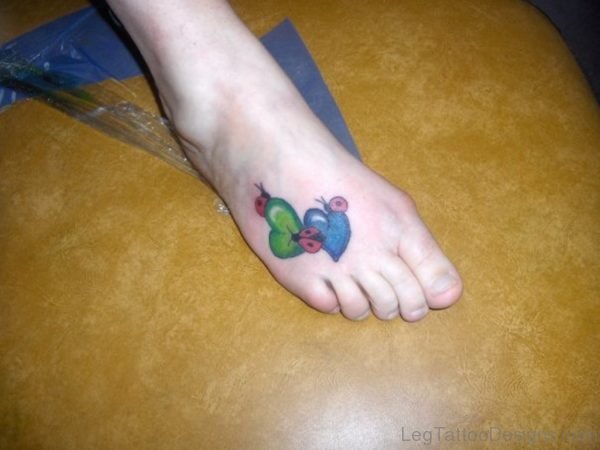 Ladybug On Heart Tattoo On Right Foot