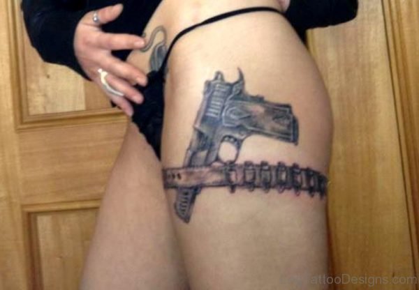 Nice Gun Tattoo On Thigh