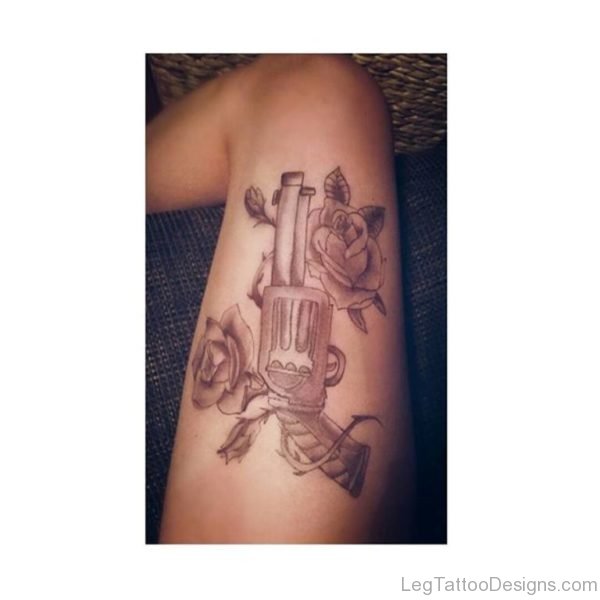 Nice Rose And Gun Tattoo