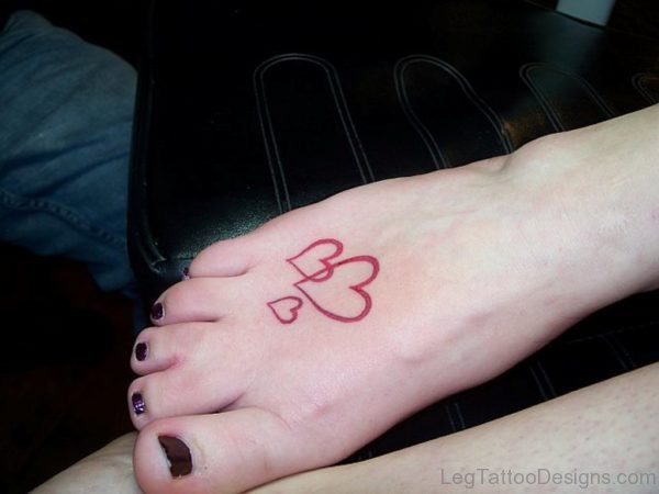 Red Ink Heart Tattoo On Foot