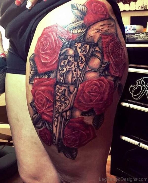 Red Rose and Gun Tattoo On Thigh