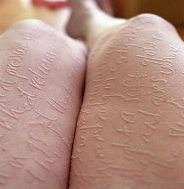 White Ink Wording Tattoo On Thigh Image